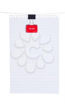 Blank note paper with red binder clip isolated on white background
