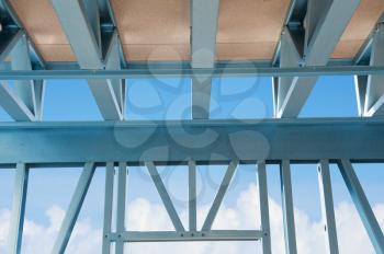 New residential construction home metal framing  against a blue sky