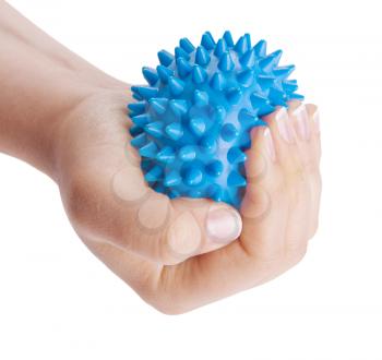 Woman's hand with Spiny plastic blue massage ball isolated on white