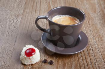 Coffee cup and coco cookie on grunge wooden background