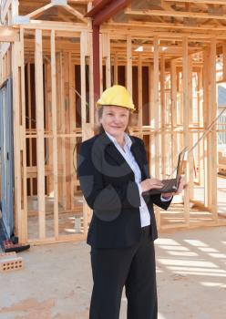 Royalty Free Photo of a Female at a Construction Site Using a Laptop