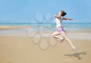 Attractive young woman doing exercise on the Beach