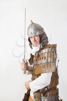 medieval warrior man wearing in ancient armor with sword