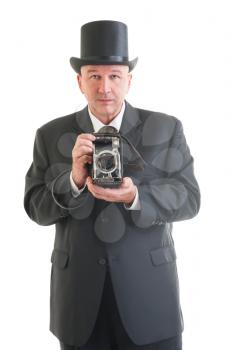 Middle aged  photographer in a retro business suit with retro camera isolated on white.