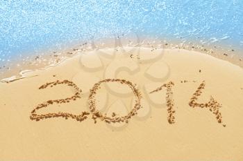 digits   2014 on the sand seashore - concept of new year and passing of time