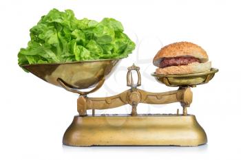 Healthy food and unhealthy food on scales.Dieting concept.Isolated.