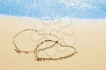 hearts on the sand seashore - love and  romantic concept 