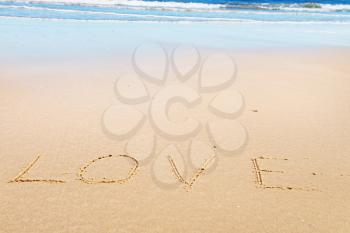 Love message on the beach sand - love and  romantic concept 