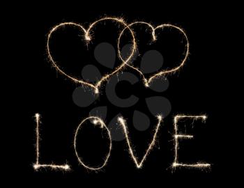 word love and two hearts from sparkler isolated on black background