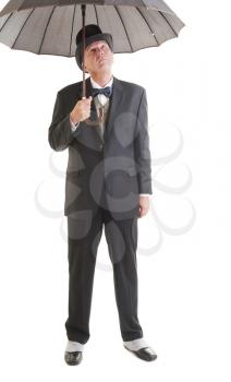 Middle aged  businessman in a retro business suit with umbrella isolated on white.