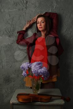 studio portrait of a beautiful woman with flowers on grunge background