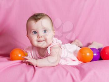 Adorable happy baby girl on pink background