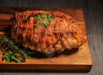 Turkey meat,chicken breast and duck fillet, stuffed with fig and pistachios, wrapped in bacon and garnished with fresh rosemary roasted as Christmas dish