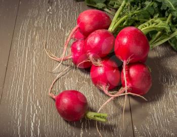 Bunch of fresh radish on vintage wooden table