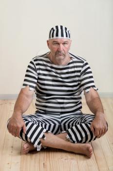 portrait of a man prisoner in prison garb
