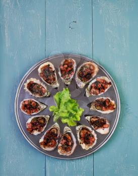 Oven baked oysters kilpatrick on special cooking and serving metal tray
