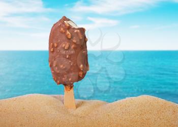 classic cold chocolate ice cream with nuts on the beach background