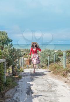 beautiful woman traveler in retro style dress  on the beach