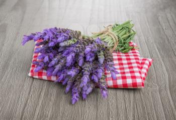 bundle of lavender flowers  on checkered tablecloth and vintage wooden table