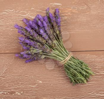 bundle of lavender flowers on on vintage wooden background 