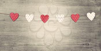 Valentines Day hearts on vintage wooden background as Valentines Day  symbol.Toned in vintage style