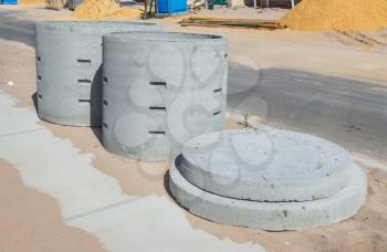 Two concrete soakwells with covers on the construction site before installation