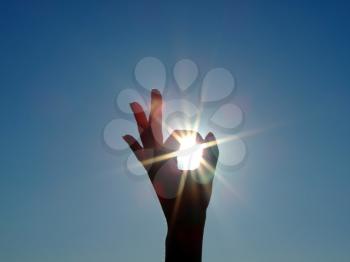 Royalty Free Photo of a Hand Circling a Sun