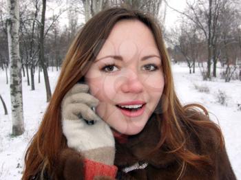 Royalty Free Photo of a Woman Talking on a Cellphone Outside in Winter