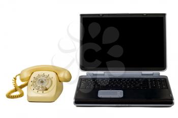 Royalty Free Photo of a Laptop and an Old Rotary Phone