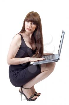 Royalty Free Photo of a Woman Crouching With a Laptop