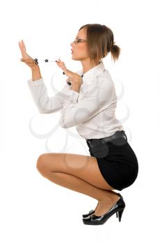 Royalty Free Photo of a Woman Squatting and Looking at Beads