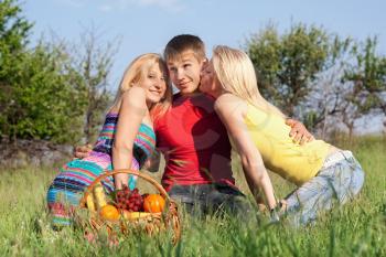 Royalty Free Photo of a Boy and Two Girls Having a Picnic