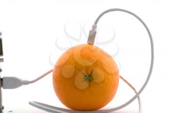 Royalty Free Photo of an Orange Connected to Cables