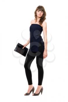 Royalty Free Photo of a Woman in Black Standing and Holding a Purse