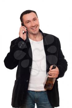 Royalty Free Photo of a Man Talking on the Phone While Holding a Whiskey Bottle