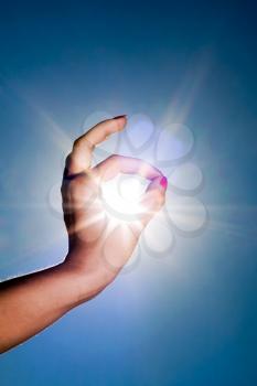 Royalty Free Photo of a Woman's Hand Circling the Sun