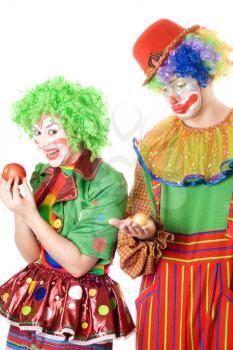 Royalty Free Photo of a Couple of Clowns Holding Apples