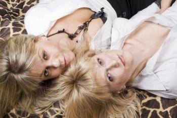 Royalty Free Photo of Two Women Lying Down on an Animal Print