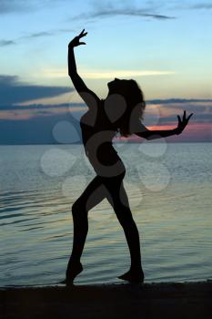 Royalty Free Photo of a Girl on a The Beach at Sunset