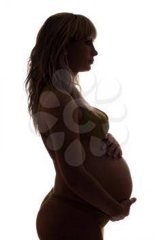 Royalty Free Photo of a Pregnant Woman in Profile