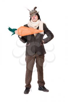 Royalty Free Photo of a Man in a Rabbit Suit Holding a Carrot