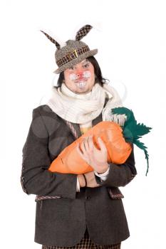 Royalty Free Photo of a Man in a With Bunny Ears Holding a Big Carrot