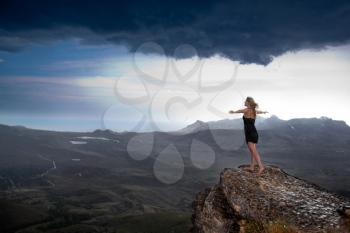 Royalty Free Photo of a Woman at the Edge of a Rock