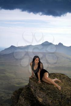 Royalty Free Photo of a Woman on a Rock