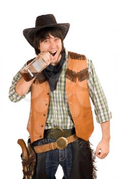 Royalty Free Photo of a Cowboy Biting off the Top of a Whiskey Bottle