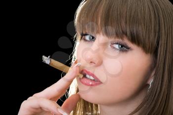 Royalty Free Photo of a Girl Smoking a Cigar