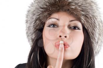 Royalty Free Photo of a Woman in a Fur Hat With Her Finger at Her Lips