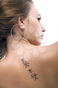 Royalty Free Photo of a Woman With a Tattoo on Her Back