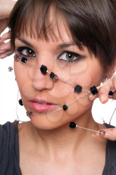 Royalty Free Photo of a Woman Holding Beads Over Her Face