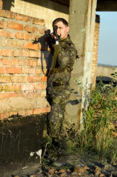 Royalty Free Photo of a Soldier at a Brick Wall
